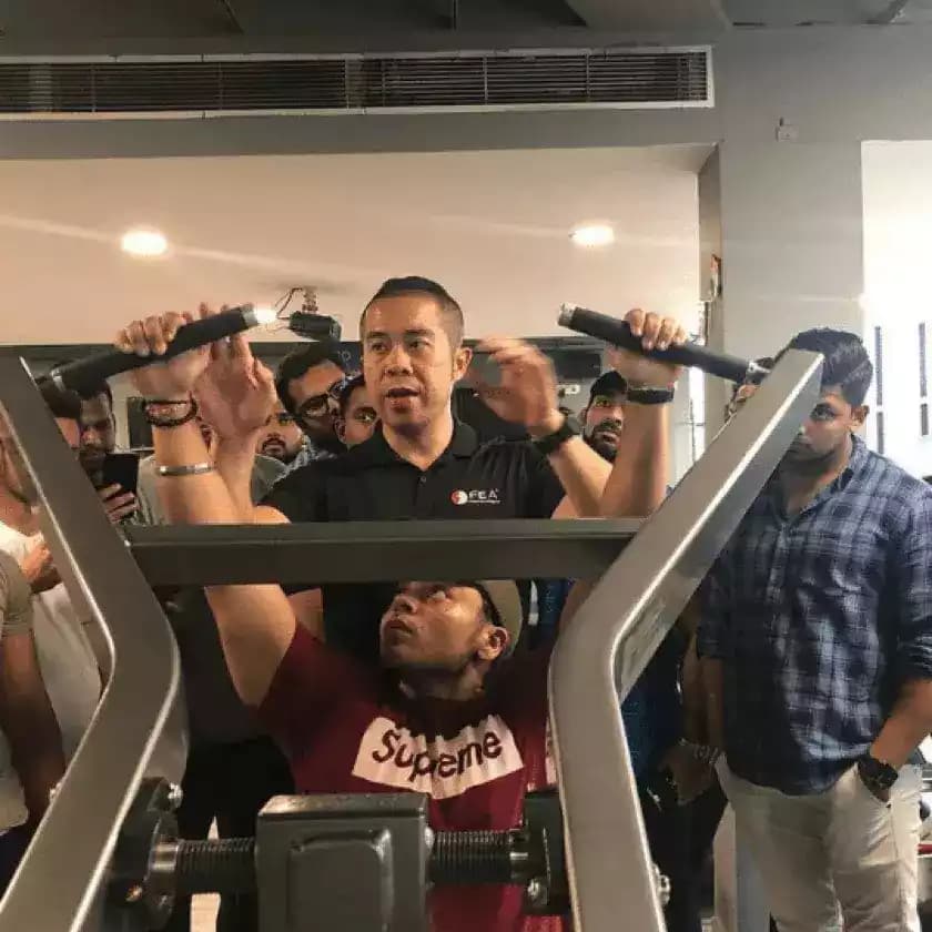 A Classic Fitness Academy faculty member coaching students on a cable machine